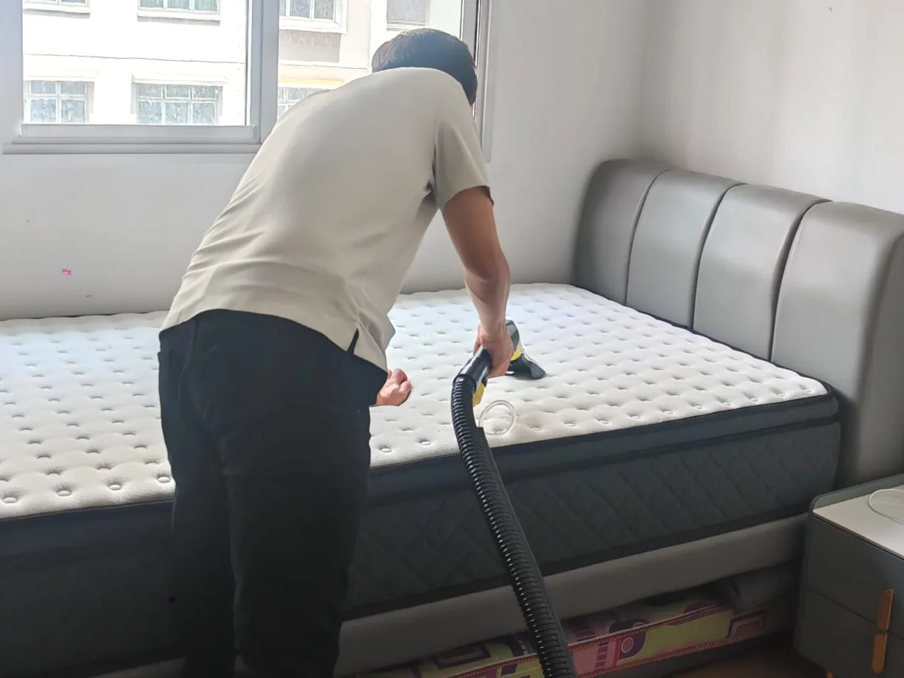 Mattress deep clean beside a window with a grey headboard