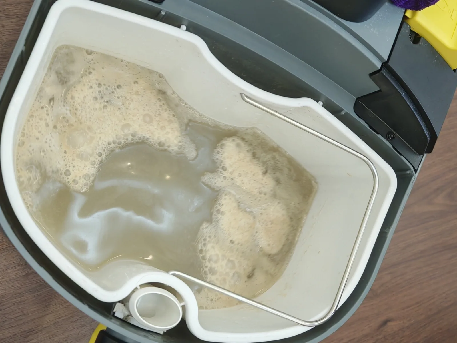 Dirty extraction water drawn out of a mattress during cleaning
